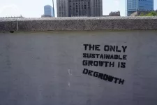 A wall with a text saying The only sustainable growth is degrowth. Photo.